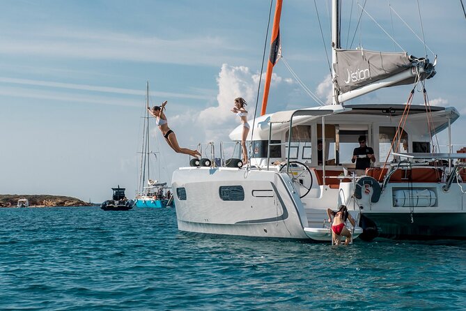 Athens Semi private Morning Catamaran cruise with meal & drinks - Vouliagmeni Beach adds a more polished coastal setting